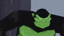 a close up of a green gorilla standing next to a building .