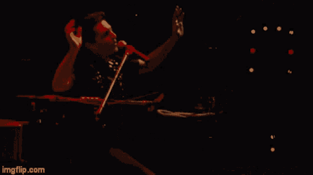 a man singing into a microphone with the url imgflip.com below him