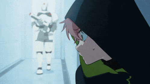 a girl in a black hood looks at a robot