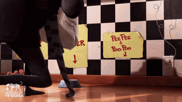 a sign that says pee pee and poo poo is taped to a checkered wall