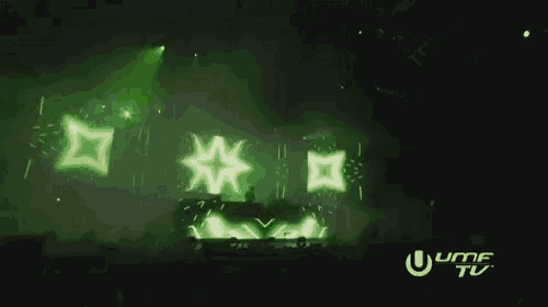 a dj performs in front of a green screen that says umf tv on it