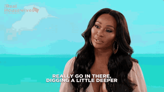 a woman says " really go in there digging a little deeper " in front of a blue background