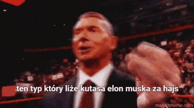 a man in a suit and tie is pointing at the camera with the words ten typ ktory lize kutasa elon muska za haj