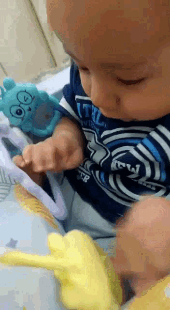a baby wearing a shirt that says ' the ' on it