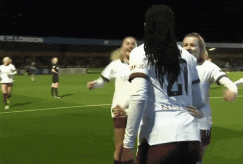 a female soccer player wearing a white jersey with the number 21 on it