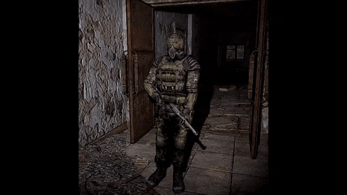 a soldier in a gas mask is standing in a dark hallway holding a gun .