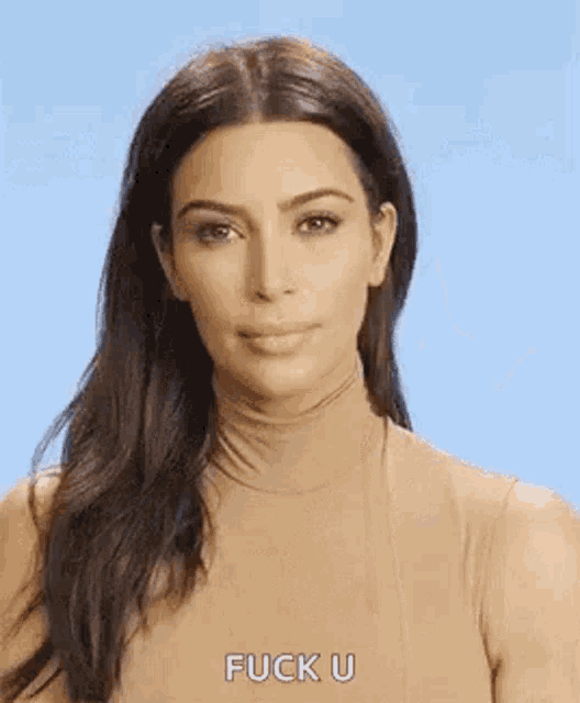 kim kardashian is wearing a turtleneck and making a face .