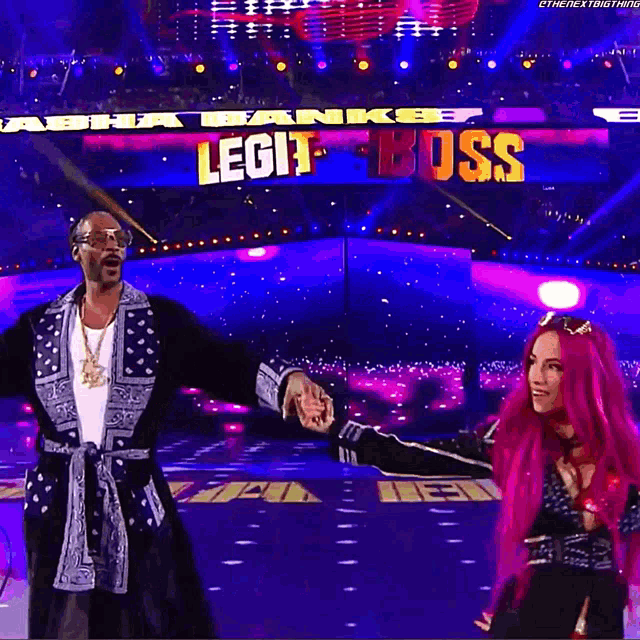 snoop dogg and sasha banks holding hands on a stage with the words legit boss behind them