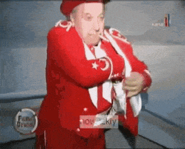 a man in a red suit and hat is holding a flag