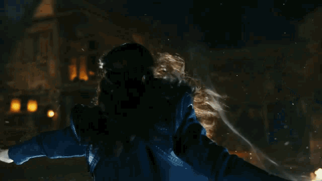 a woman with long hair is surrounded by a glowing light