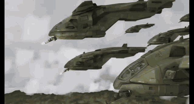 a group of military helicopters are flying in the sky