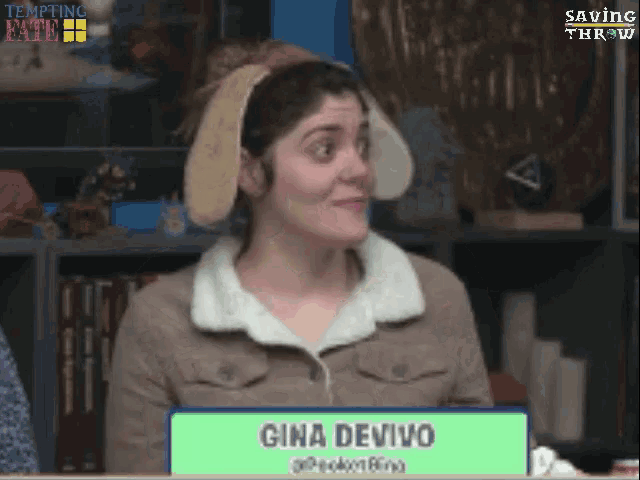 gina devivo is wearing bunny ears and holding a sign