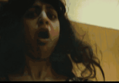 a close up of a woman 's face with a scary look on her face .