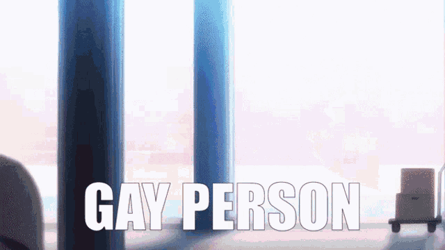 a sign that says gay person on it in front of a window