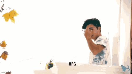 a man stands in front of a white box that says hfg on it