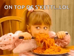 a little girl is eating a plate of spaghetti with a fork and knife .