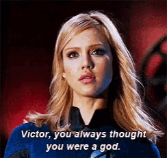 a woman in a blue superhero costume is talking to victor .