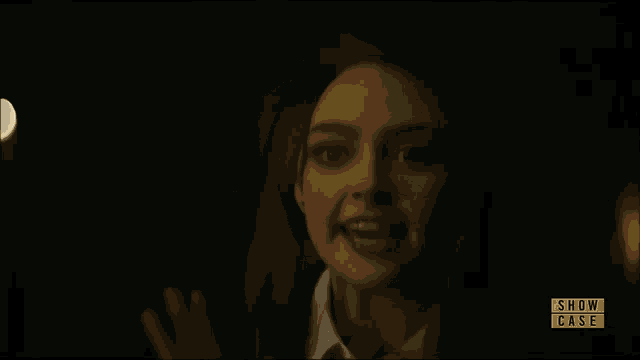 a blurred image of a person with a show case logo in the corner