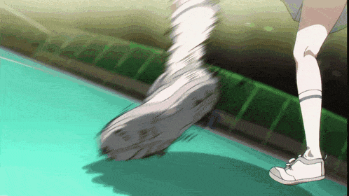 a person wearing a pair of white sneakers is running on a green floor