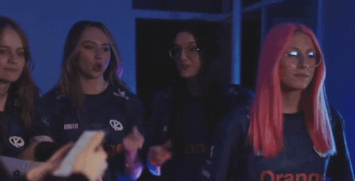 a group of girls with pink hair and glasses are giving each other the middle finger