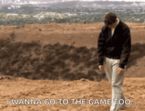 a man walking in the dirt with the words " i wanna go to the game too " behind him