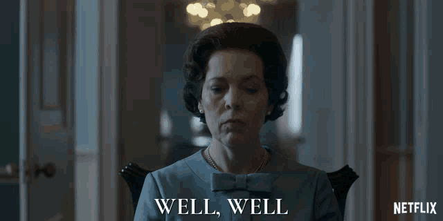 a woman in a blue dress is sitting in a chair with the words well well behind her