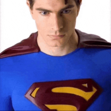 a man in a superman costume has a red cape