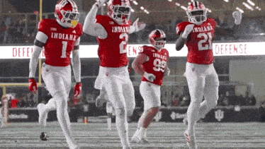 a group of indiana football players are celebrating a touchdown