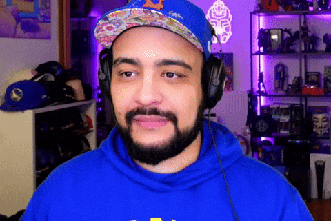 a man with a beard wearing headphones and a hat with the letter n on it