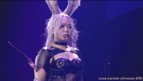 a woman in a bunny costume is standing in front of a red background with luna lorain written on the bottom