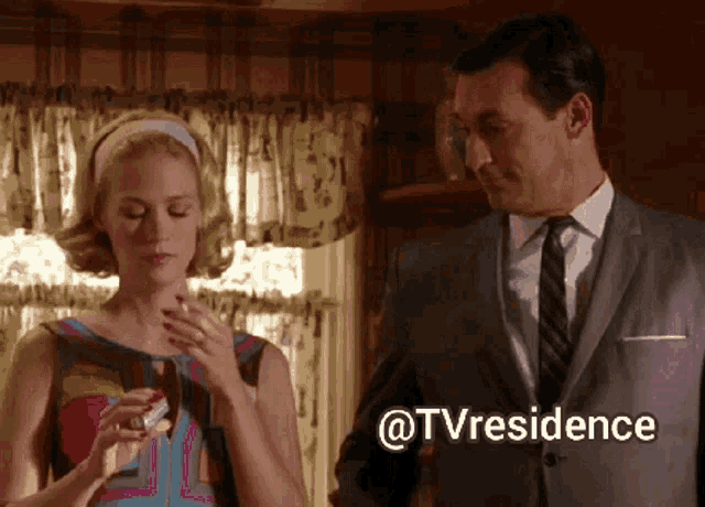 a man in a suit and tie is standing next to a woman who is smoking a cigarette and the words @tvresidence are above them
