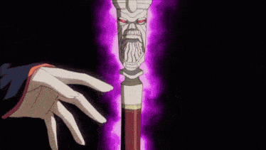 a person is holding a cane with a skull face on it