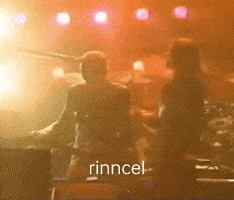 a blurry photo of a band with the name rincel on the bottom right