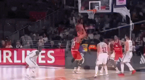 a basketball game is being played in front of an airlines ad