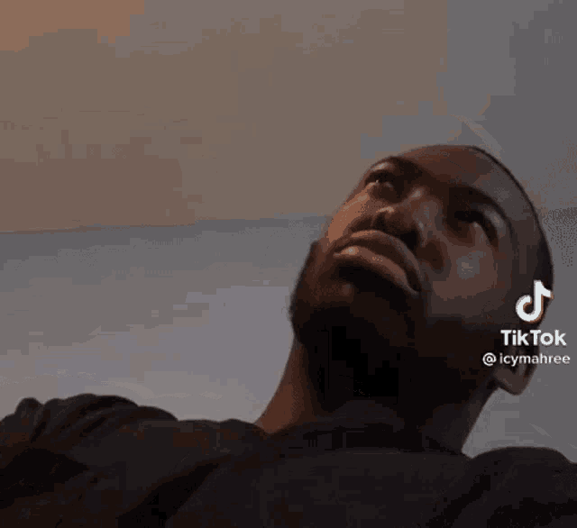 a man with a beard is looking up at the camera with a tiktok watermark