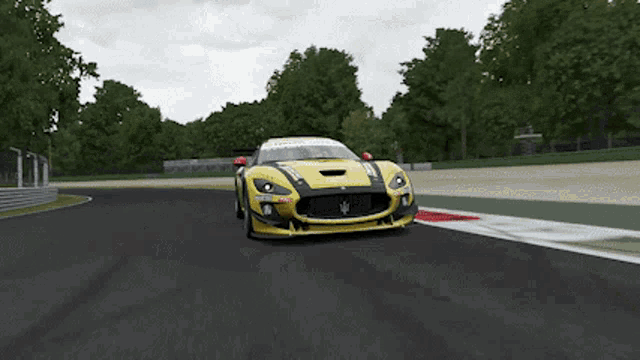a yellow race car is driving on a track