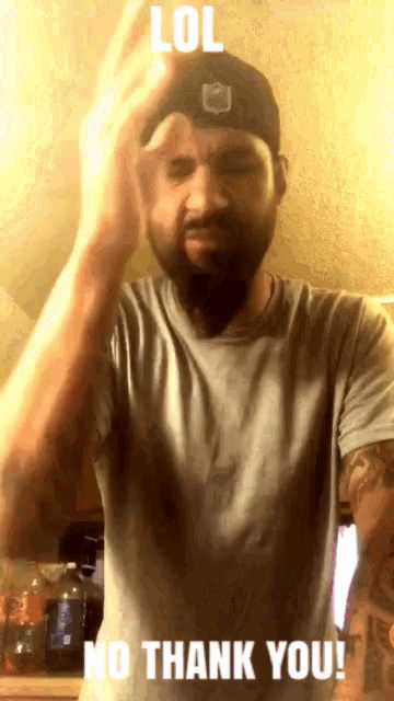 a man with a beard wearing a hat and a t-shirt says " lol no thank you "