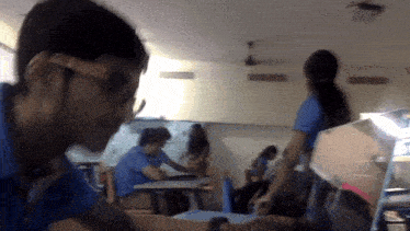 a blurry picture of a group of people sitting at tables
