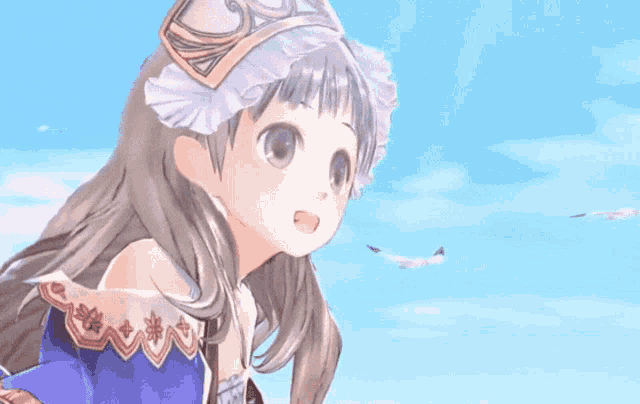a girl in a blue dress with a crown on her head stands in front of a blue sky