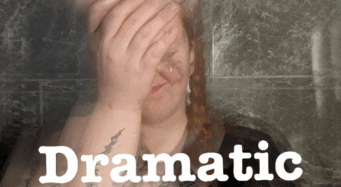 a woman is covering her face with her hands and the word dramatic is on the bottom