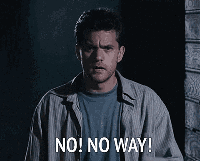 a man is standing in a dark room and says no no way