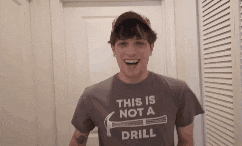 a man wearing a shirt that says " this is not a drill "