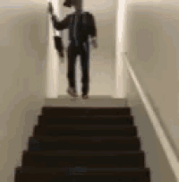 a person is walking down a set of stairs with an umbrella .