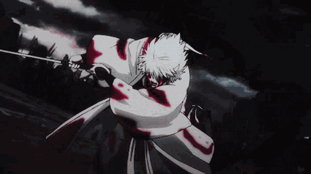 a man with blood on his clothes is holding a sword in his hand