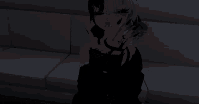 a girl in a black dress is standing in a dark room with her arms outstretched