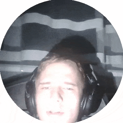 a man wearing headphones looks at the camera in a dark room