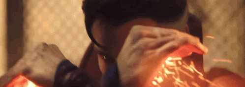 a close up of a person 's face with a red light coming out of it