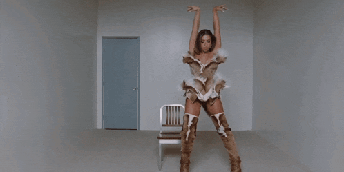 a woman is standing in a room with a chair and a door