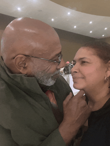 a man and a woman are looking at each other