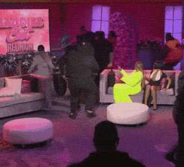 a group of people are gathered in a room with a sign that says ladies cat reunion
